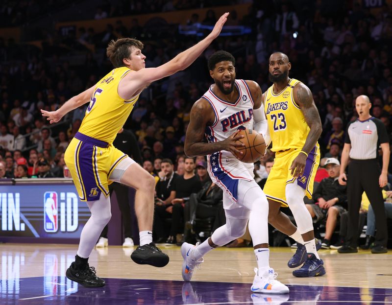 LOS ANGELES, CALIFORNIA - NOVEMBER 08: Paul George #8 of the Philadelphia 76ers drives to the basket between Austin Reaves #15 and LeBron James #23 of the Los Angeles Lakers during the first half at Crypto.com Arena on November 08, 2024 in Los Angeles, California. (Photo by Harry How/Getty Images) NOTE TO USER: User expressly acknowledges and agrees that, by downloading and/or using this Photograph, user is consenting to the terms and conditions of the Getty Images License Agreement. (Photo by Harry How/Getty Images)