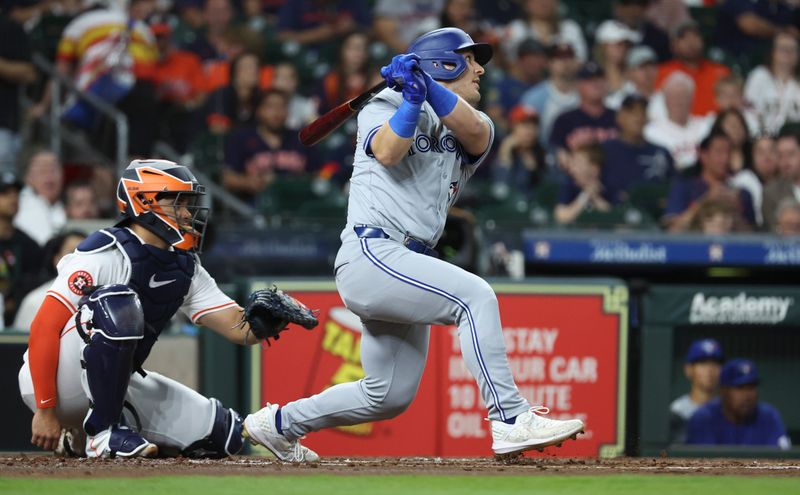 Apr 3, 2024; Houston, Texas, USA; Toronto Blue Jays left fielder Daulton Varsho (25) hits a double during the second inning against the Houston Astros at Minute Maid Park. Mandatory Credit: Troy Taormina-USA TODAY Sports