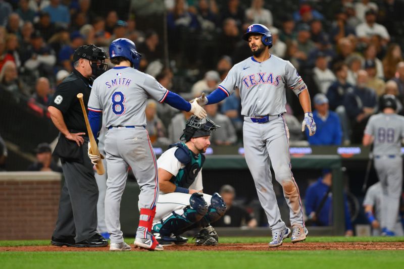 Sep 12, 2024; Seattle, Washington, USA; Texas Rangers shortstop Josh Smith (8) and second baseman Marcus Semien (2) celebrate after Semien hit a home run against the Seattle Mariners during the eighth inning at T-Mobile Park. Mandatory Credit: Steven Bisig-Imagn Images