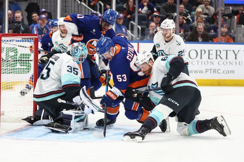 Nov 23, 2025; Elmont, New York, USA;  Seattle Kraken goaltender Joey Daccord (35) defends the net as defenseman Adam Larsson (6) and New York Islanders center Casey Cizikas (53) battle for control of the puck in the third period at UBS Arena. Mandatory Credit: Wendell Cruz-Imagn Images