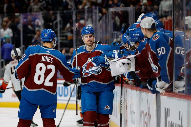 Dec 5, 2023; Denver, Colorado, USA; Colorado Avalanche defenseman Kurtis MacDermid (56) celebrates his goal with defenseman Caleb Jones (82) and teammates in the first period against the Anaheim Ducks at Ball Arena. Mandatory Credit: Isaiah J. Downing-USA TODAY Sports