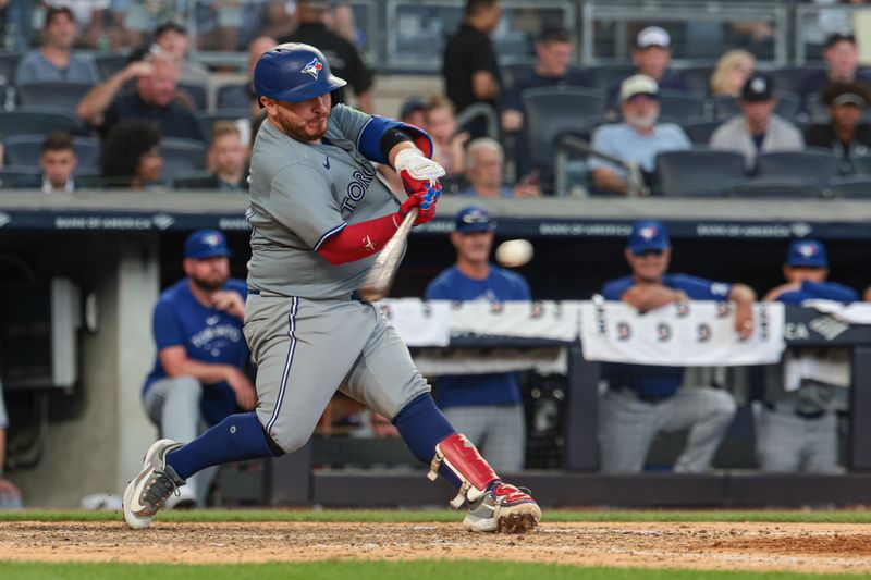 Aug 4, 2024; Bronx, New York, USA; Toronto Blue Jays catcher Alejandro Kirk (30) hits an RBI sacrifice fly during the seventh inning against the New York Yankees at Yankee Stadium. Mandatory Credit: Vincent Carchietta-USA TODAY Sports