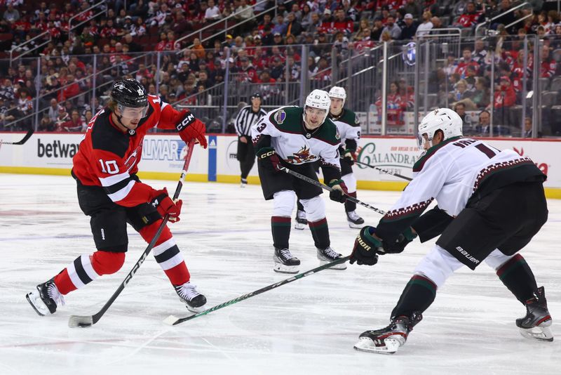 Oct 13, 2023; Newark, New Jersey, USA; New Jersey Devils right wing Alexander Holtz (10) shoots the puck against the Arizona Coyotes during the second period at Prudential Center. Mandatory Credit: Ed Mulholland-USA TODAY Sports