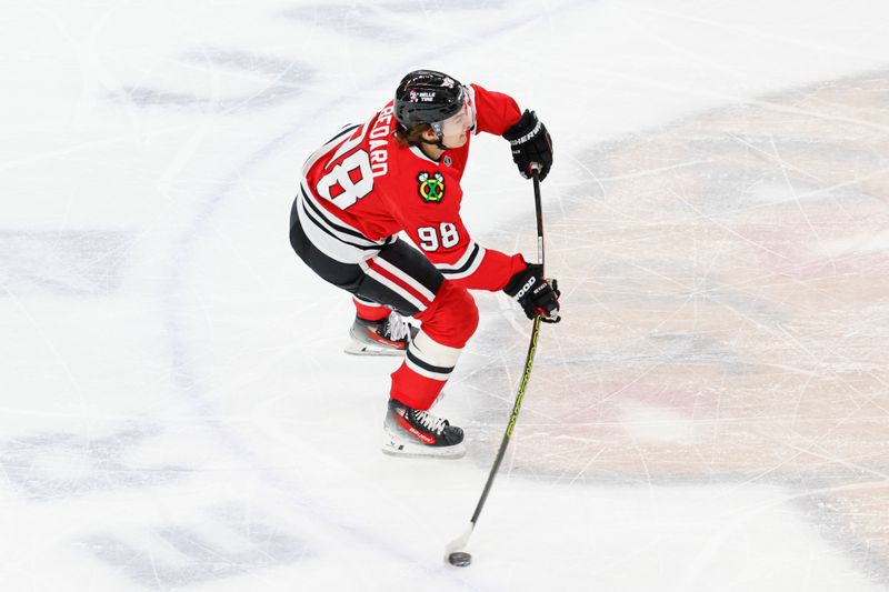 Jan 13, 2025; Chicago, Illinois, USA; Chicago Blackhawks center Connor Bedard (98) shoots against the Calgary Flames during the second period at United Center. Mandatory Credit: Kamil Krzaczynski-Imagn Images