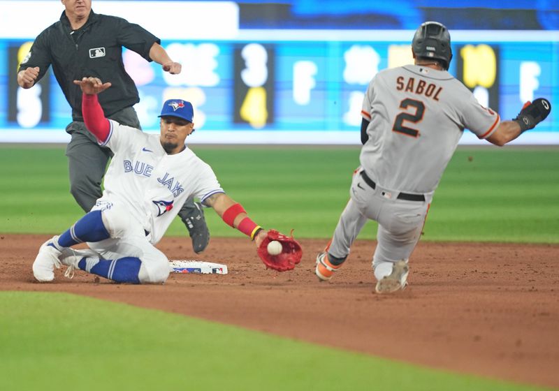 Jun 29, 2023; Toronto, Ontario, CAN; Toronto Blue Jays second baseman Santiago Espinal (5) tags out San Francisco Giants catcher Blake Sabol (2) at second base during the ninth inning at Rogers Centre. Mandatory Credit: Nick Turchiaro-USA TODAY Sports