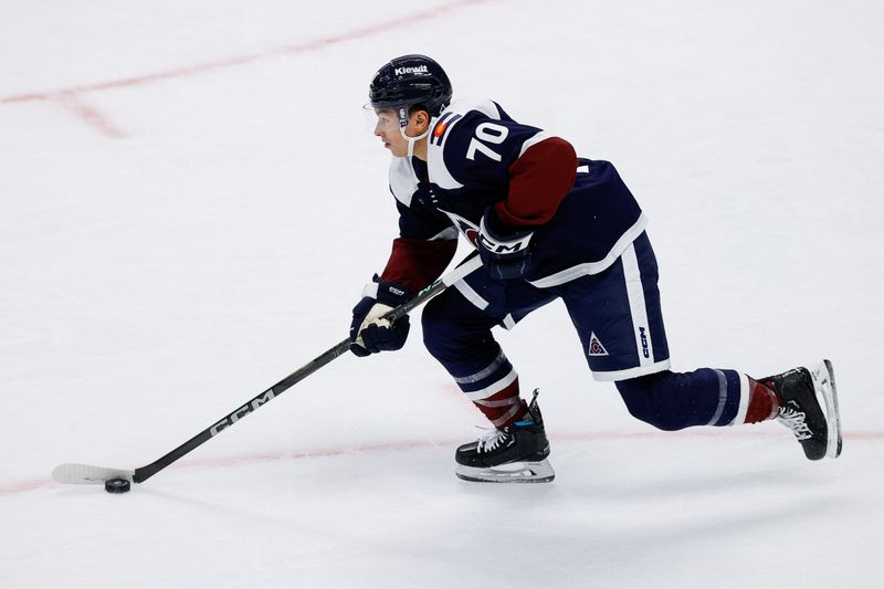 Oct 28, 2024; Denver, Colorado, USA; Colorado Avalanche defenseman Sam Malinski (70) controls the puck in the first period against the Chicago Blackhawks at Ball Arena. Mandatory Credit: Isaiah J. Downing-Imagn Images