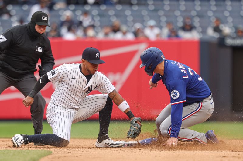 May 22, 2025; Bronx, New York, USA; New York Yankees starting pitcher Clarke Schmidt (36) steals second base, beating the tag by New York Yankees second baseman Jorbit Vivas (90) during the sixth inning at Yankee Stadium. Mandatory Credit: Vincent Carchietta-Imagn Images