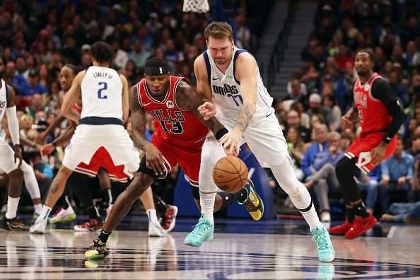 DALLAS, TEXAS - NOVEMBER 01: Luka Doncic #77 of the Dallas Mavericks and Torrey Craig #13 of the Chicago Bulls fight for the ball in the second half at American Airlines Center on November 01, 2023 in Dallas, Texas. NOTE TO USER: User expressly acknowledges and agrees that, by downloading and or using this photograph, User is consenting to the terms and conditions of the Getty Images License Agreement. (Photo by Tim Heitman/Getty Images)