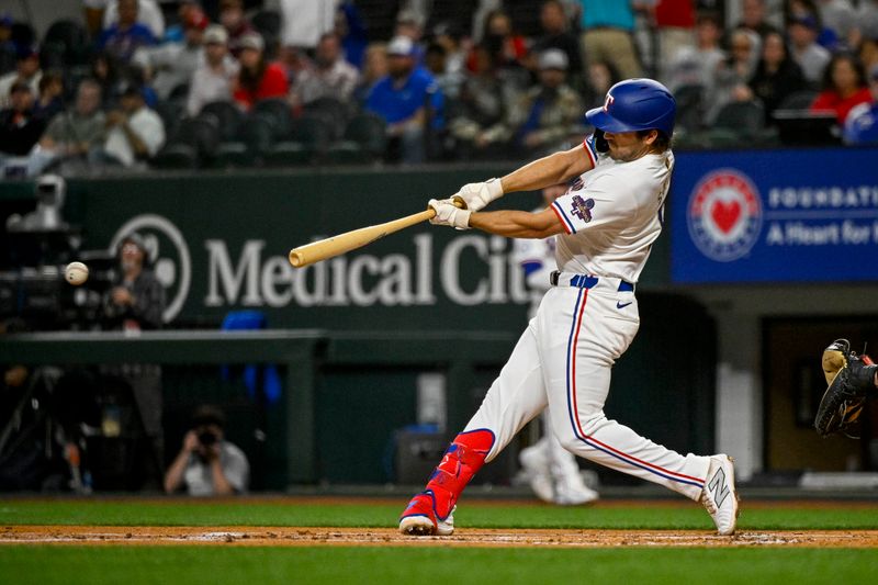 Apr 10, 2024; Arlington, Texas, USA; Texas Rangers third baseman Josh Smith (8) hits a single and drives in a run against the Oakland Athletics during the first inning at Globe Life Field. Mandatory Credit: Jerome Miron-USA TODAY Sports