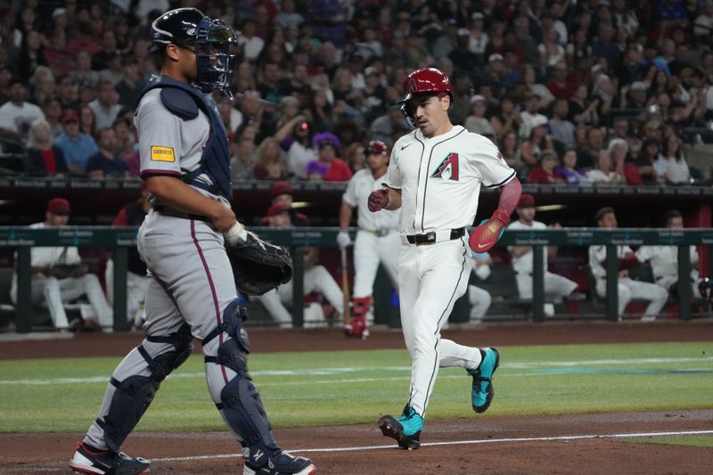 Apr 27, 2025; Phoenix, Arizona, USA; Arizona Diamondbacks outfielder Corbin Carroll (7) scores a run against the Atlanta Braves in the first inning at Chase Field. Mandatory Credit: Rick Scuteri-Imagn Images