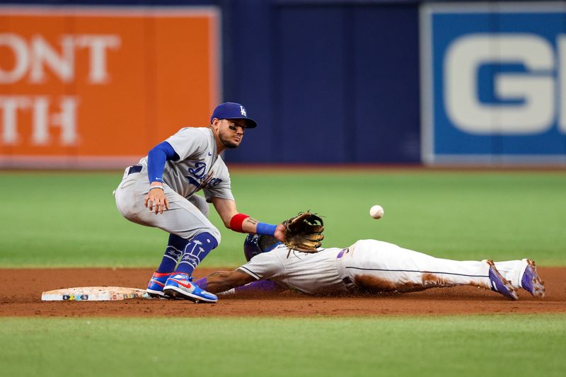 May 26, 2023; St. Petersburg, Florida, USA;  Tampa Bay Rays shortstop Wander Franco (5) steals second base from Los Angeles Dodgers shortstop Miguel Rojas (11) in the seventh inning at Tropicana Field. Mandatory Credit: Nathan Ray Seebeck-USA TODAY Sports