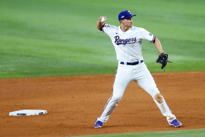 Oct 10, 2023; Arlington, Texas, USA; Texas Rangers shortstop Corey Seager (5) throws to first in the sixth inning against the Baltimore Orioles during game three of the ALDS for the 2023 MLB playoffs at Globe Life Field. Mandatory Credit: Andrew Dieb-USA TODAY Sports