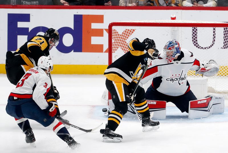 Jan 2, 2024; Pittsburgh, Pennsylvania, USA;  Washington Capitals goaltender Darcy Kuemper (35) defends the net against Pittsburgh Penguins center Evgeni Malkin (71) and center Sidney Crosby (center) during the third period at PPG Paints Arena. Mandatory Credit: Charles LeClaire-USA TODAY Sports