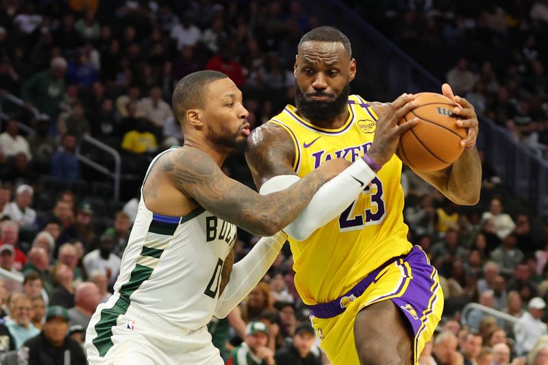 MILWAUKEE, WISCONSIN - OCTOBER 10: LeBron James #23 of the Los Angeles Lakers drives to the basket against Damian Lillard #0 of the Milwaukee Bucks during the first half of a preseason game at Fiserv Forum on October 10, 2024 in Milwaukee, Wisconsin.  NOTE TO USER: User expressly acknowledges and agrees that, by downloading and or using this photograph, User is consenting to the terms and conditions of the Getty Images License Agreement. (Photo by Stacy Revere/Getty Images)