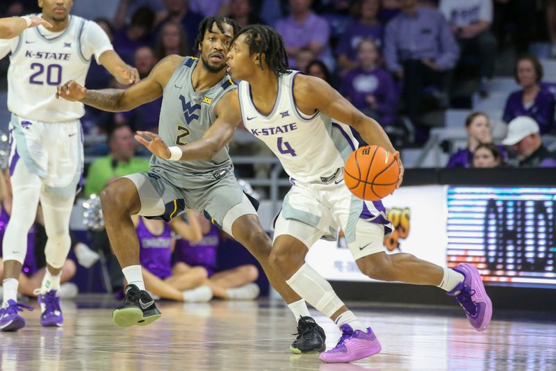 Feb 26, 2024; Manhattan, Kansas, USA; West Virginia Mountaineers guard Kobe Johnson (2) guards Kansas State Wildcats guard Dai Dai Ames (4) during the second half at Bramlage Coliseum. Mandatory Credit: Scott Sewell-USA TODAY Sports