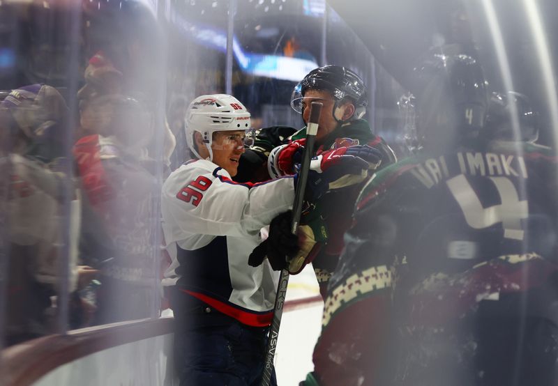 Dec 4, 2023; Tempe, Arizona, USA; Washington Capitals right wing Nicolas Aube-Kubel (96) fights Arizona Coyotes defenseman Michael Kesselring (5) in the third period at Mullett Arena. Mandatory Credit: Mark J. Rebilas-USA TODAY Sports