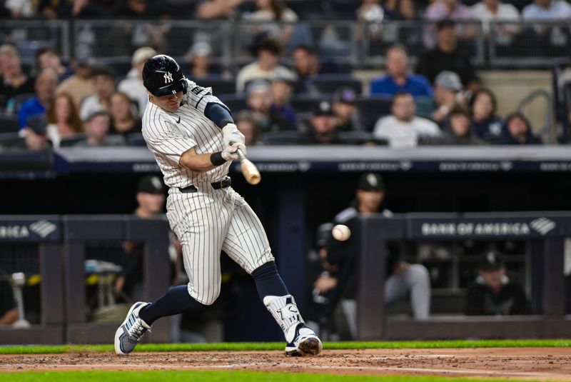 Sep 23, 2025; Bronx, New York, USA; New York Yankees shortstop Anthony Volpe (11) hits a single against the Chicago White Sox during the second inning at Yankee Stadium. Mandatory Credit: John Jones-Imagn Images