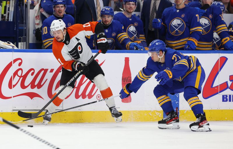 Apr 5, 2024; Buffalo, New York, USA;  Philadelphia Flyers right wing Travis Konecny (11) makes a pass as Buffalo Sabres right wing JJ Peterka (77) defends during the third period at KeyBank Center. Mandatory Credit: Timothy T. Ludwig-USA TODAY Sports