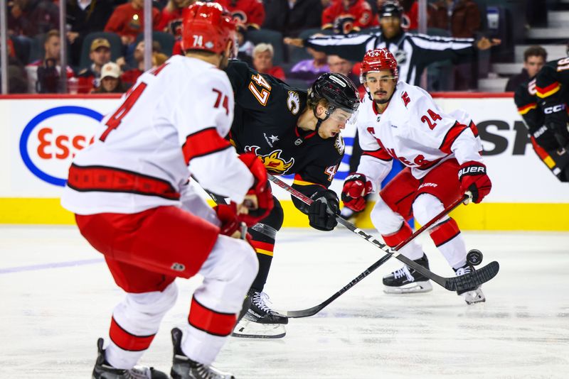 Oct 24, 2024; Calgary, Alberta, CAN; Calgary Flames center Connor Zary (47) controls the puck against the Carolina Hurricanes during the third period at Scotiabank Saddledome. Mandatory Credit: Sergei Belski-Imagn Images