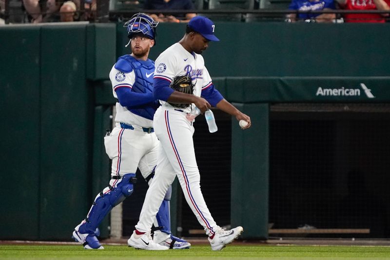 Sep 19, 2024; Arlington, Texas, USA; Texas Rangers pitcher Kumar Rocker (80) and catcher Carson Kelly (18) walk in from the bullpen prior to a game against the Toronto Blue Jays at Globe Life Field. Mandatory Credit: Raymond Carlin III-Imagn Images