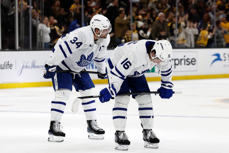 Oct 26, 2024; Boston, Massachusetts, USA; Toronto Maple Leafs right wing Mitch Marner (16) and center Auston Matthews (34) hang their heads after their 4-3 loss in overtime to the Boston Bruins at TD Garden. Mandatory Credit: Winslow Townson-Imagn Images