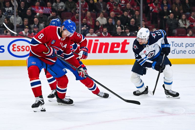 Dec 3, 2025; Montreal, Quebec, CAN; Montreal Canadiens defenseman Mike Matheson (8) intercepts the puck with his skate against Winnipeg Jets center Gabriel Vilardi (13) during the second period at Bell Centre. Mandatory Credit: David Kirouac-Imagn Images