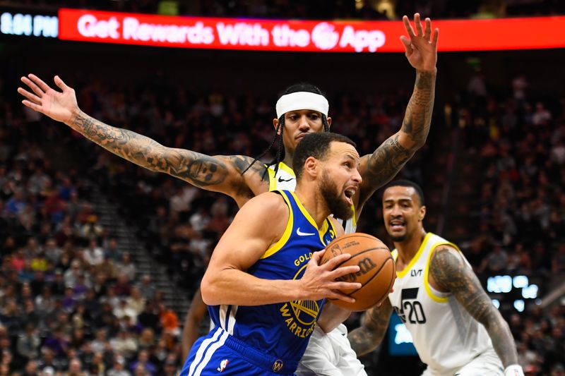 SALT LAKE CITY, UTAH - FEBRUARY 15: Stephen Curry #30 of the Golden State Warriors drives into Jordan Clarkson #00 of the Utah Jazz during the first half of a game at Delta Center on February 15, 2024 in Salt Lake City, Utah. NOTE TO USER: User expressly acknowledges and agrees that, by downloading and or using this photograph, User is consenting to the terms and conditions of the Getty Images License Agreement. (Photo by Alex Goodlett/Getty Images)