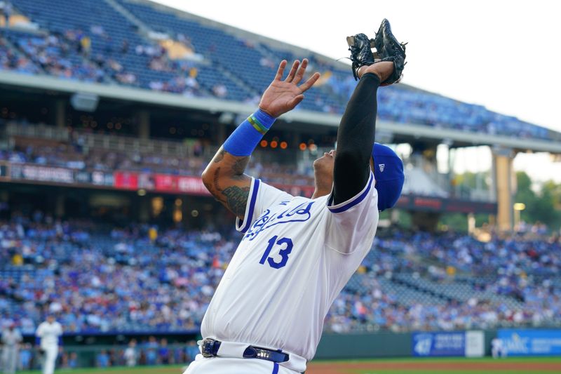 Aug 20, 2024; Kansas City, Missouri, USA; Kansas City Royals first baseman Salvador Perez (13) fields a foul ball against the Los Angeles Angels in the first inning at Kauffman Stadium. Mandatory Credit: Denny Medley-USA TODAY Sports