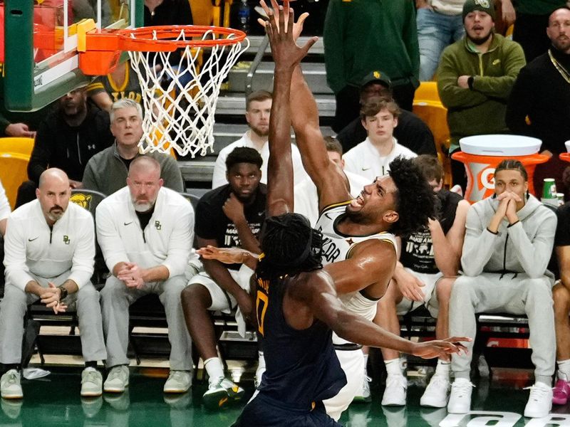 Feb 15, 2025; Waco, Texas, USA;  Baylor Bears forward Norchad Omier (15) scores a basket against West Virginia Mountaineers center Eduardo Andre (0) during the second half at Paul and Alejandra Foster Pavilion. Mandatory Credit: Chris Jones-Imagn Images