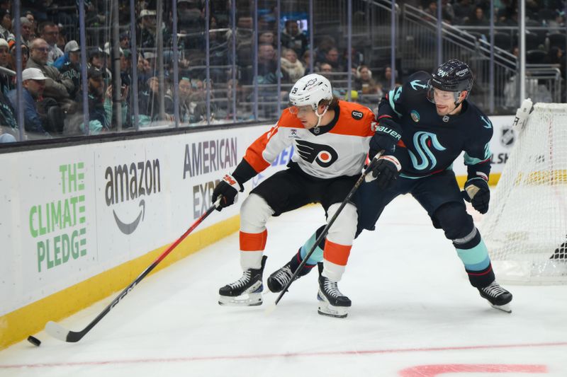 Dec 28, 2025; Seattle, Washington, USA; Philadelphia Flyers right wing Nikita Grebenkin (29) and Seattle Kraken defenseman Jamie Oleksiak (24) play the puck during the third period at Climate Pledge Arena. Mandatory Credit: Steven Bisig-Imagn Images