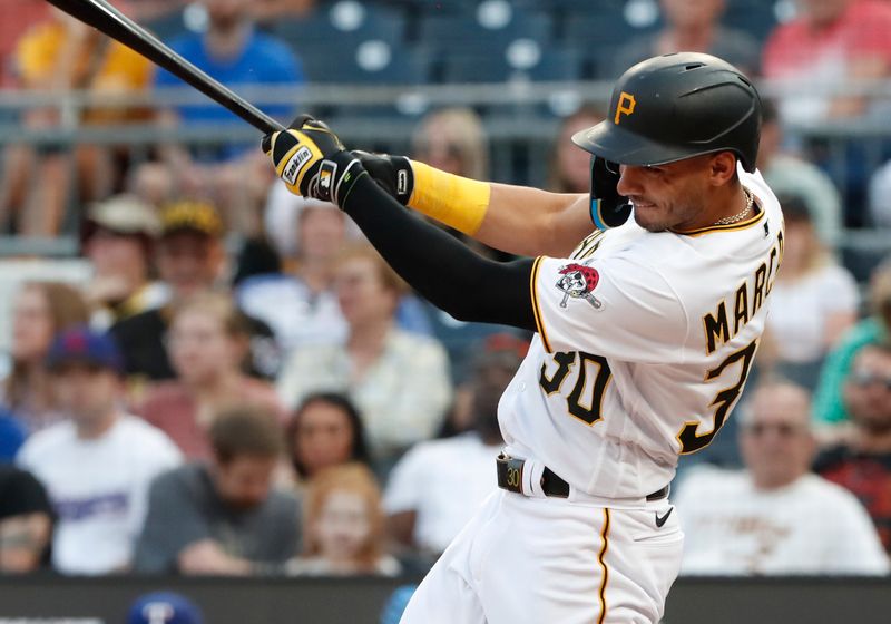 May 22, 2023; Pittsburgh, Pennsylvania, USA;  Pittsburgh Pirates shortstop Tucupita Marcano (30) hits a single against the Texas Rangers during the fourth inning at PNC Park. Mandatory Credit: Charles LeClaire-USA TODAY Sports