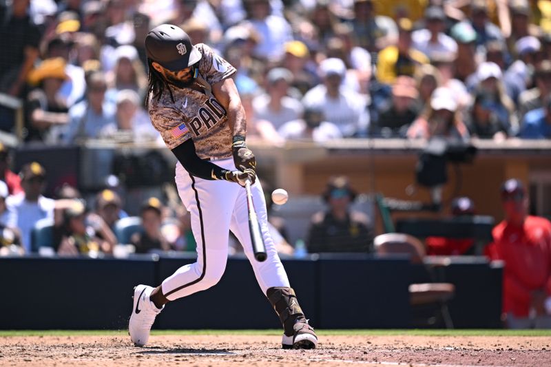 Jun 25, 2023; San Diego, California, USA; San Diego Padres right fielder Fernando Tatis Jr. (23) hits an RBI single against the Washington Nationals during the fifth inning at Petco Park. Mandatory Credit: Orlando Ramirez-USA TODAY Sports