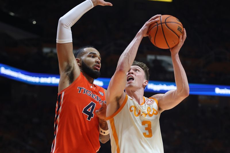 Feb 28, 2024; Knoxville, Tennessee, USA; Tennessee Volunteers guard Dalton Knecht (3) goes to the basket against Auburn Tigers forward Johni Broome (4) during the second half at Thompson-Boling Arena at Food City Center. Mandatory Credit: Randy Sartin-USA TODAY Sports