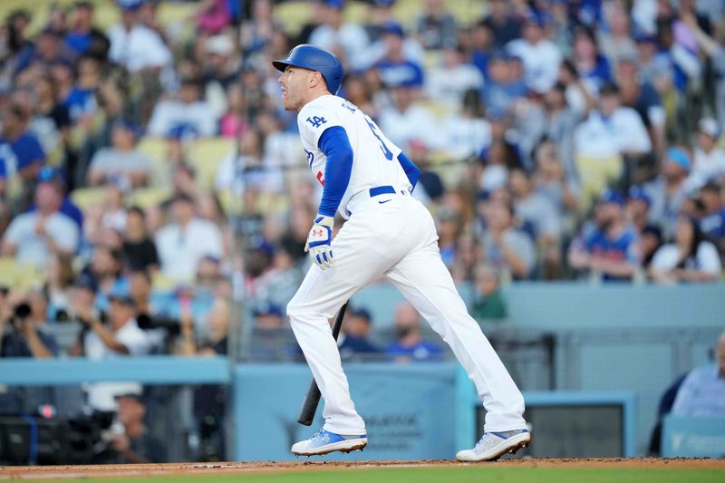 Jul 3, 2024; Los Angeles, California, USA; Los Angeles Dodgers first baseman Freddie Freeman (5) hits a three-run home run in the first inning against the Arizona Diamondbacks at Dodger Stadium. Mandatory Credit: Kirby Lee-USA TODAY Sports