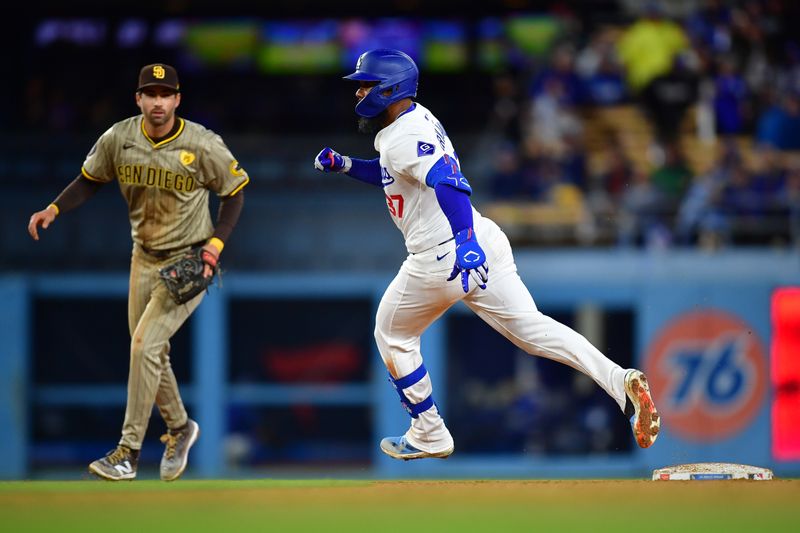 Apr 13, 2024; Los Angeles, California, USA; Los Angeles Dodgers right fielder Teoscar Hernandez (37) runs to third on an error commited by San Diego Padres right fielder Fernando Tatis Jr. (23) during the seventh inning at Dodger Stadium. Mandatory Credit: Gary A. Vasquez-USA TODAY Sports