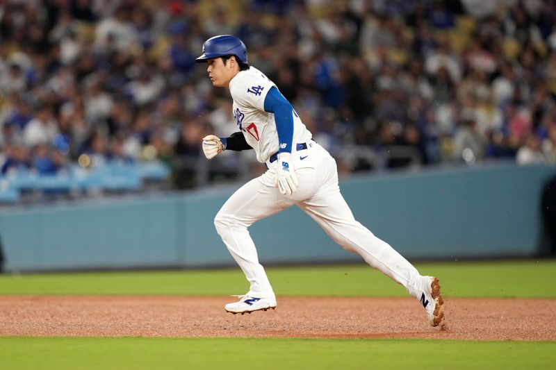 May 21, 2024; Los Angeles, California, USA; Los Angeles Dodgers designated hitter Shohei Ohtani (17) steals third base in the fourth inning against the Arizona Diamondbacks at Dodger Stadium. Mandatory Credit: Kirby Lee-USA TODAY Sports