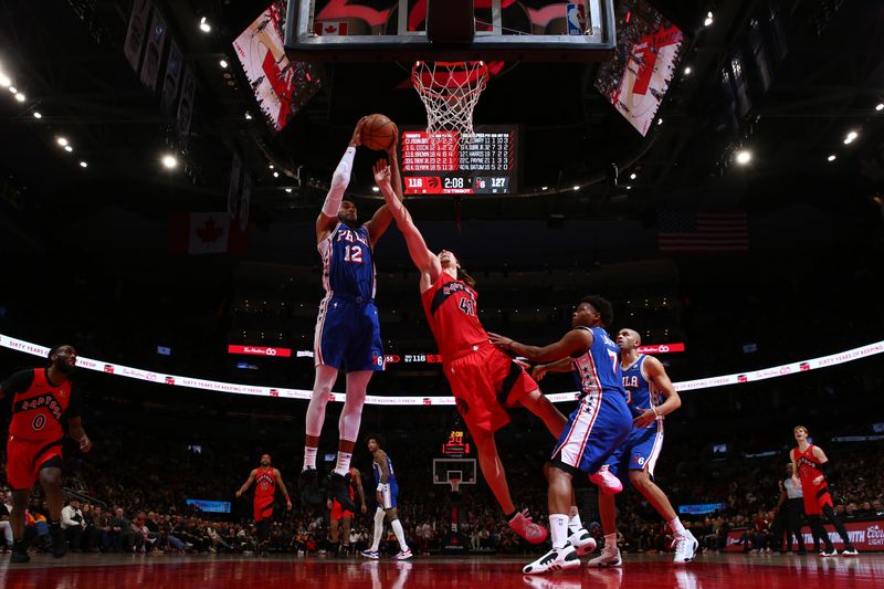 TORONTO, CANADA - MARCH 31: Tobias Harris #12 of the Philadelphia 76ers grabs a rebound during the game against the Toronto Raptors on March 31, 2024 at the Scotiabank Arena in Toronto, Ontario, Canada.  NOTE TO USER: User expressly acknowledges and agrees that, by downloading and or using this Photograph, user is consenting to the terms and conditions of the Getty Images License Agreement.  Mandatory Copyright Notice: Copyright 2024 NBAE (Photo by Vaughn Ridley/NBAE via Getty Images)