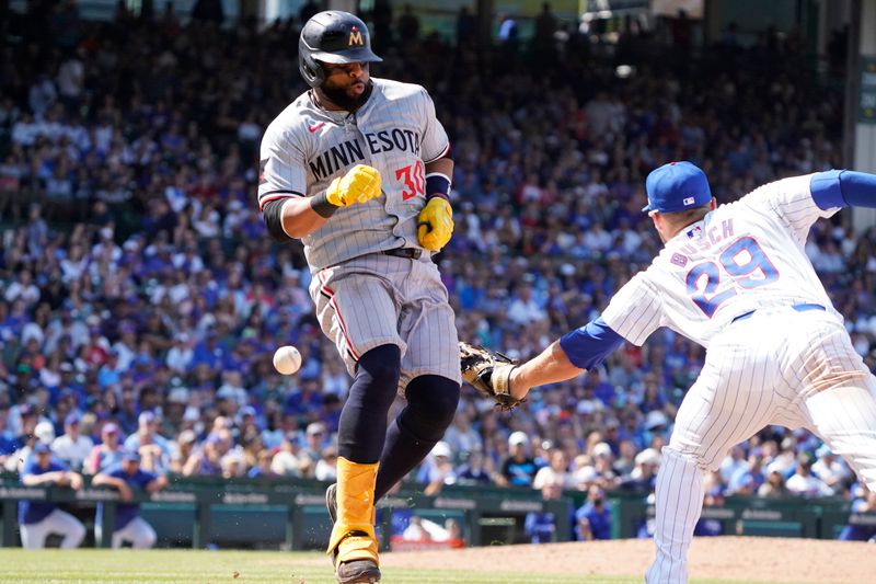 Aug 7, 2024; Chicago, Illinois, USA; Minnesota Twins first baseman Carlos Santana (30) is safe at first base as Chicago Cubs first baseman Michael Busch (29) tries to make a tag during the sixth inning at Wrigley Field. Mandatory Credit: David Banks-USA TODAY Sports