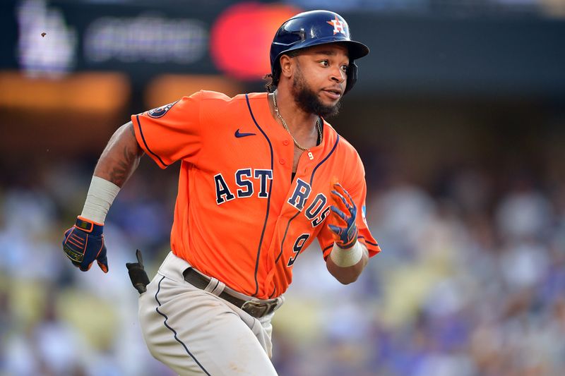 Jun 25, 2023; Los Angeles, California, USA; Houston Astros designated hitter Corey Julks (9) hits a single against the Los Angeles Dodgers during the tenth inning at Dodger Stadium. Mandatory Credit: Gary A. Vasquez-USA TODAY Sports