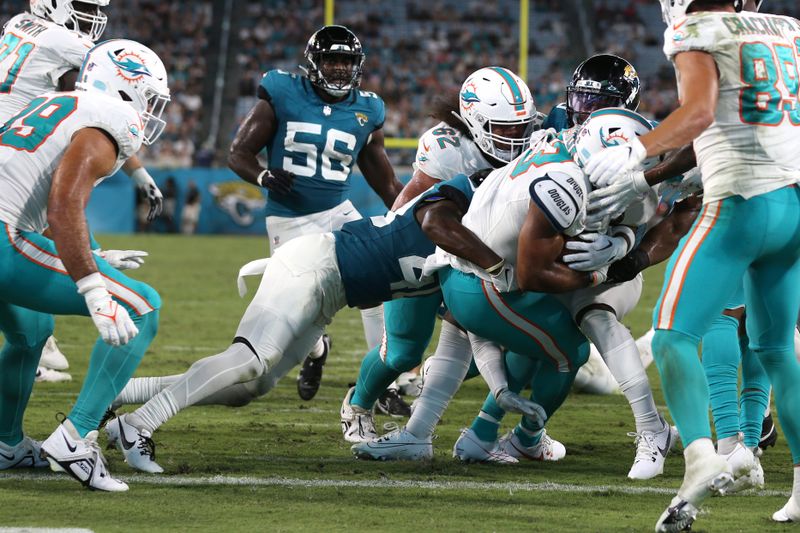 Miami Dolphins running back Chris Brooks (33) runs to score a touchdown during the second half of an NFL preseason football game against the Jacksonville Jaguars, Saturday, Aug. 26, 2023, in Jacksonville, Fla. (AP Photo/Gary McCullough)