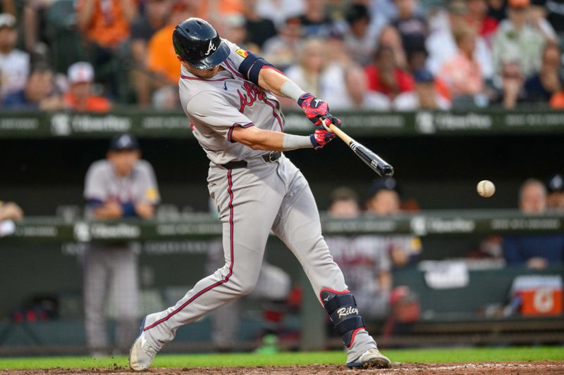 Jun 12, 2024; Baltimore, Maryland, USA; Atlanta Braves third base Austin Riley (27) hits a single during the sixth inning against the Baltimore Orioles at Oriole Park at Camden Yards. Mandatory Credit: Reggie Hildred-USA TODAY Sports