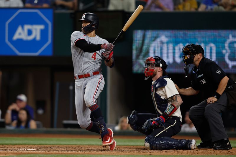 Sep 2, 2023; Arlington, Texas, USA; Minnesota Twins shortstop Carlos Correa (4) singles in a run in the tenth inning against the Texas Rangers at Globe Life Field. Mandatory Credit: Tim Heitman-USA TODAY Sports