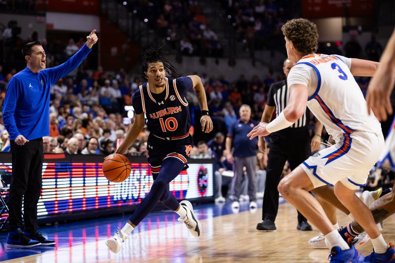 Feb 10, 2024; Gainesville, Florida, USA; Auburn Tigers guard Chad Baker-Mazara (10) drives to the basket against Florida Gators center Micah Handlogten (3) during the first half at Exactech Arena at the Stephen C. O'Connell Center. Mandatory Credit: Matt Pendleton-USA TODAY Sports