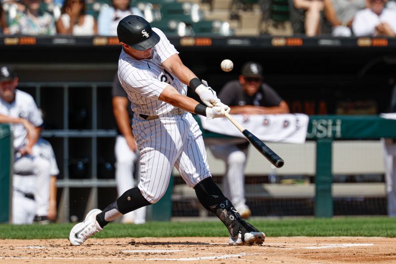 Sep 15, 2024; Chicago, Illinois, USA; Chicago White Sox first baseman Andrew Vaughn (21) hits an RBI-single against the Oakland Athletics during the first inning at Guaranteed Rate Field. Mandatory Credit: Kamil Krzaczynski-Imagn Images