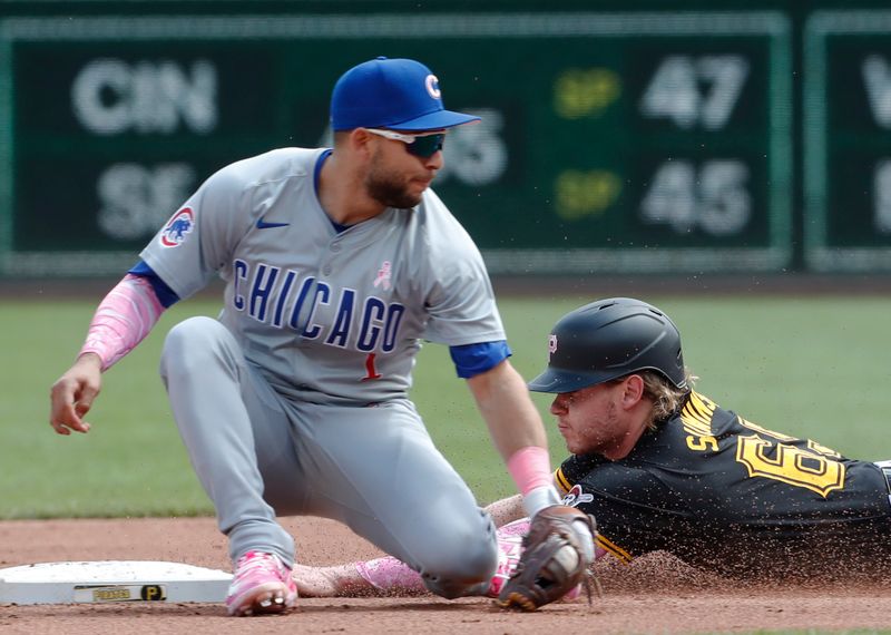 May 12, 2024; Pittsburgh, Pennsylvania, USA;  Pittsburgh Pirates center fielder Jack Suwinski (65) steals second base as Chicago Cubs second baseman Nick Madrigal (1) takes a late throw during the fourth inning at PNC Park. Mandatory Credit: Charles LeClaire-USA TODAY Sports