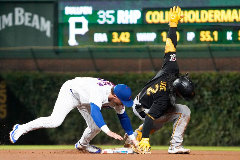 Sep 21, 2023; Chicago, Illinois, USA; Pittsburgh Pirates designated hitter Connor Joe (2) is tagged out at second base by Chicago Cubs second baseman Nico Hoerner (2) against the Chicago Cubs during the eighth inning at Wrigley Field. Mandatory Credit: David Banks-USA TODAY Sports