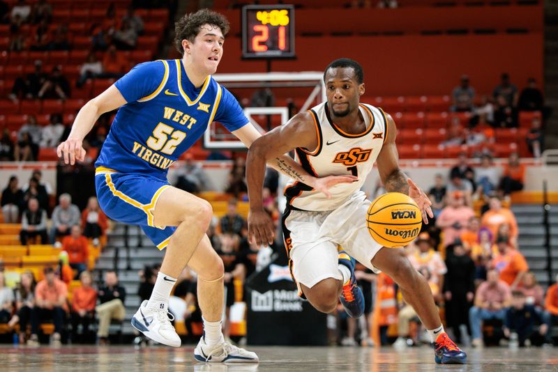 Feb 24, 2026; Stillwater, Oklahoma, USA; Oklahoma State Cowboys guard Kanye Clary (1) drives around West Virginia Mountaineers forward Treysen Eaglestaff (52) during the first half at Gallagher-Iba Arena. Mandatory Credit: William Purnell-Imagn Images