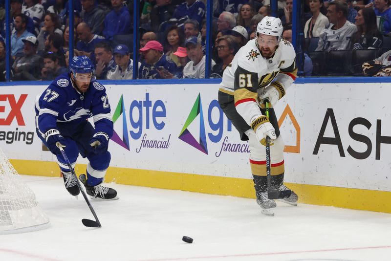 Oct 17, 2024; Tampa, Florida, USA; Vegas Golden Knights right wing Mark Stone (61) passes the puck as Tampa Bay Lightning defenseman Ryan McDonagh (27) defends during the second period at Amalie Arena. Mandatory Credit: Kim Klement Neitzel-Imagn Images