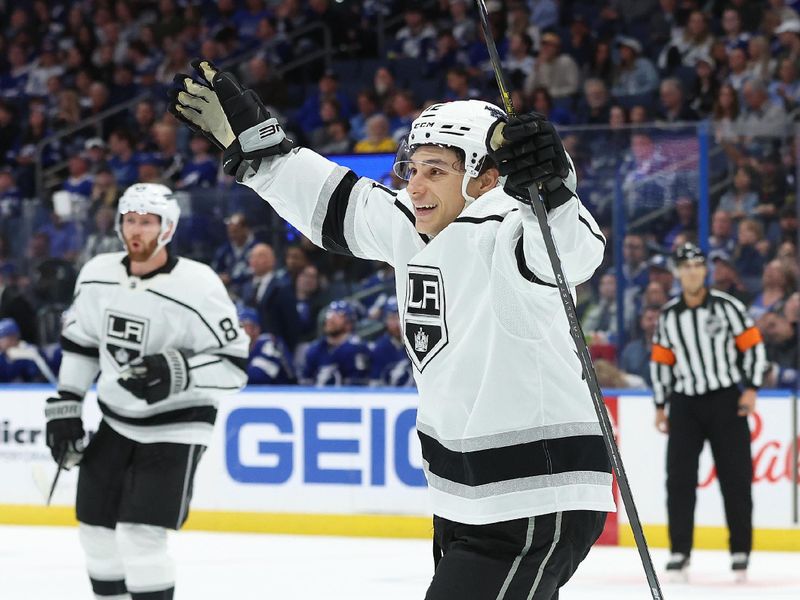 Jan 9, 2024; Tampa, Florida, USA; Los Angeles Kings left wing Trevor Moore (12) celebrates after defenseman Matt Roy (3) (not pictured) scored a goal against the Tampa Bay Lightning during the second period at Amalie Arena. Mandatory Credit: Kim Klement Neitzel-USA TODAY Sports