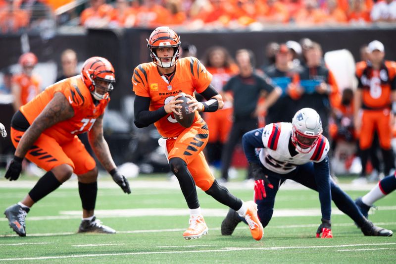 Cincinnati Bengals quarterback Joe Burrow (9) carries the ball in the second half during an NFL football game against the New England Patriots on Sunday, Sept. 8, 2024, in Cincinnati. (AP Photo/Emilee Chinn)